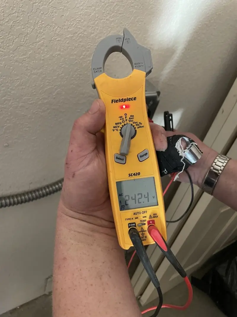 Voltage testing with clamp meter during Ceiling Fan Installation in Coweta